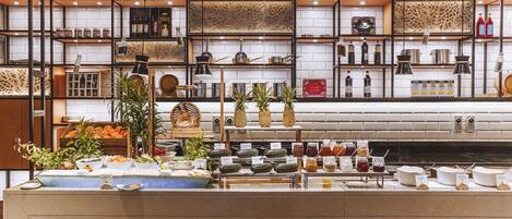 A buffet with various food items and beverages, neatly arranged on shelves and counters.