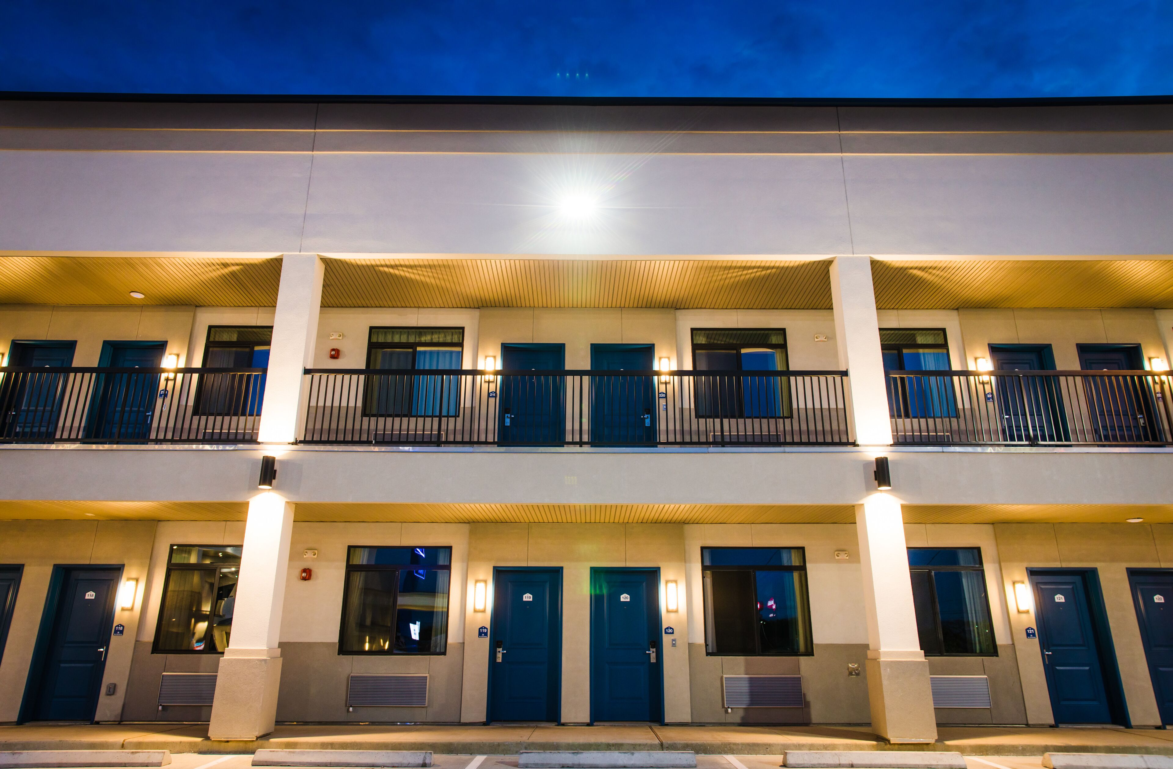 Ein mehrstöckiges Hotel mit schlichter Fassade, Balkonen und gleichmäßig angeordneten Eingängen.
