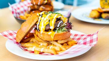 A burger with fries on a plate.