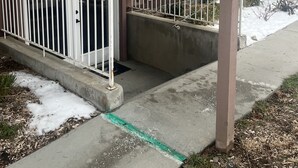 A building entrance with a covered porch, a sign indicating an Airbnb and VRBO entrance, and a gated door. - 2000 sq foot exec apt./private vacation/quiet neighborhood close to ski resorts (Draper)