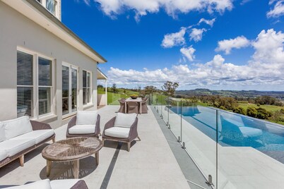 Expansive Hamptons home on acreage, with pool, spa, gym, tennis court & views.