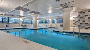 An indoor swimming pool with clear markings, large windows, and a tiled wall. - Embassy Suites by Hilton Rockford Riverfront (Rockford)