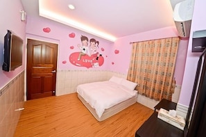 A bedroom with a wooden floor, a bed with white bedding, a wall-mounted TV, a door, and a window with curtains. - Painted Holiday (Liuqiu)