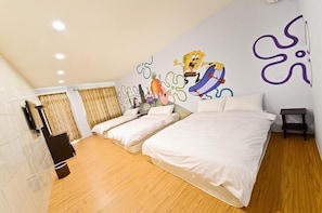 A hotel room with a large bed, two smaller beds, a wall mural, and a wooden floor. - Painted Holiday (Liuqiu)
