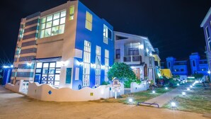 A modern building with large windows and a well-lit entrance. - Indigo Homestay (Magong)