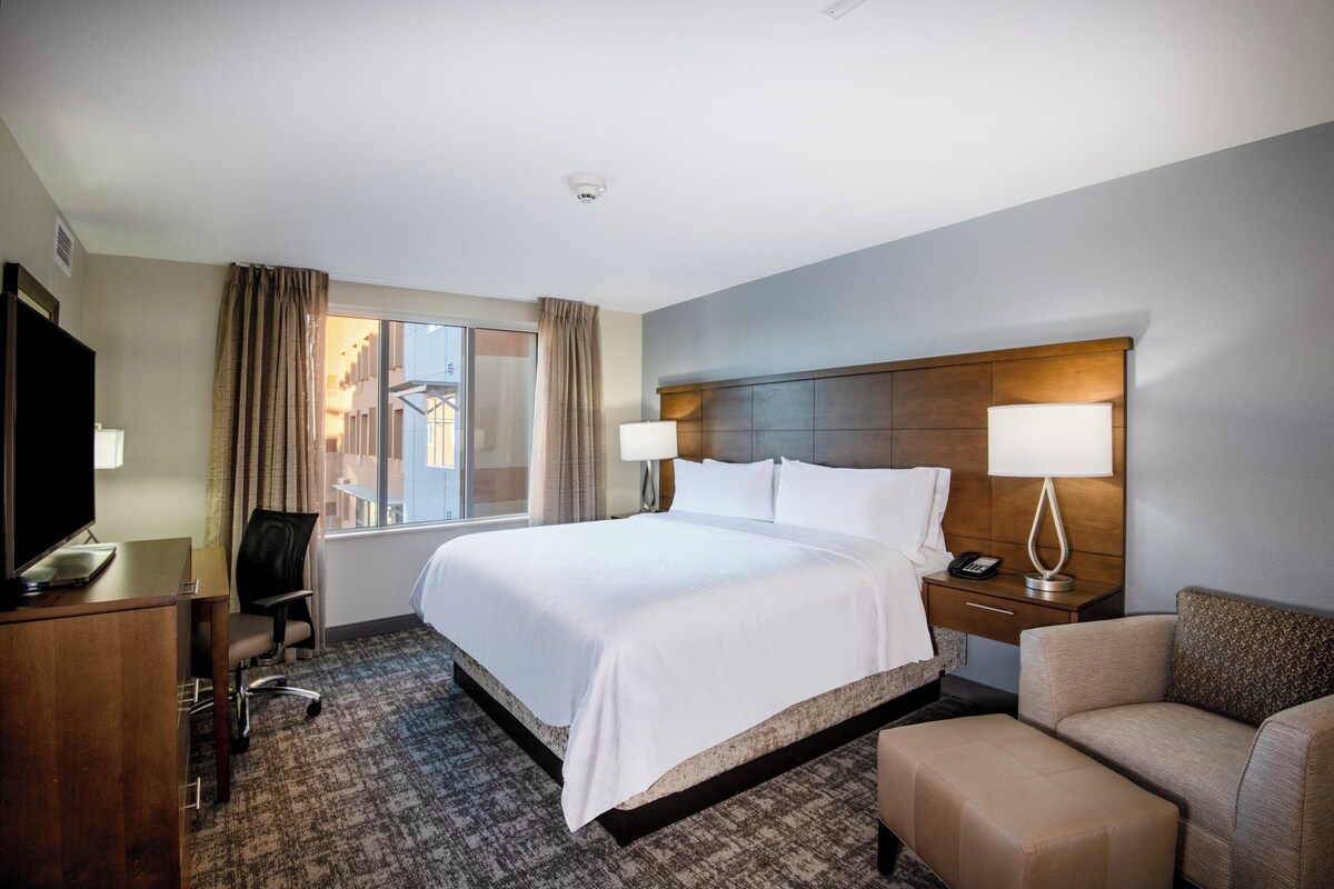 Premium bedding, desk, laptop workspace, blackout drapes