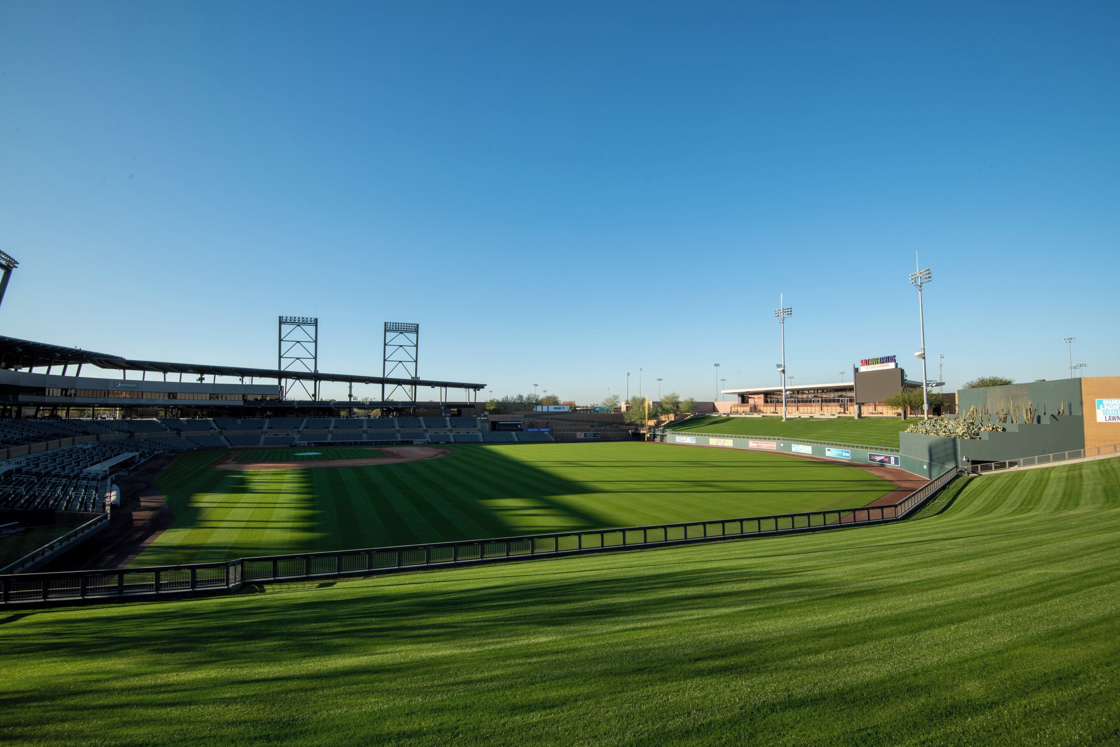 A baseball stadium with a large seating area, a field, and a scoreboard.