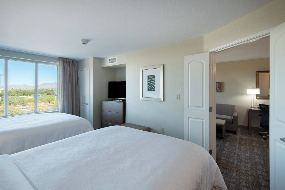 Premium bedding, desk, laptop workspace, blackout drapes