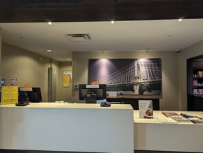 A hotel reception area with a large bridge mural, a reception desk, and a snack bar. - Staybridge Suites Scottsdale - Talking Stick by IHG (Scottsdale)