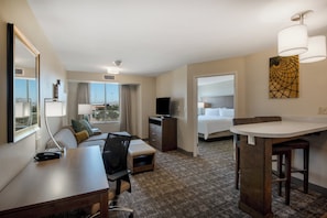 A hotel room with a desk, chair, sofa, TV, and a bed. - Staybridge Suites Scottsdale - Talking Stick by IHG (Scottsdale)