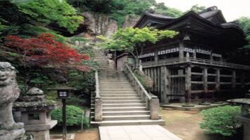 A traditional building with a staircase leading to a wooden structure.