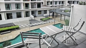 A rooftop pool area with a clear view of a multi-story building in the background. - YOYO Homestay (Johor Bahru)