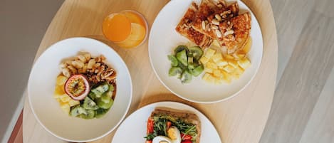 A breakfast tray with toast, fruit, and a cup of coffee.