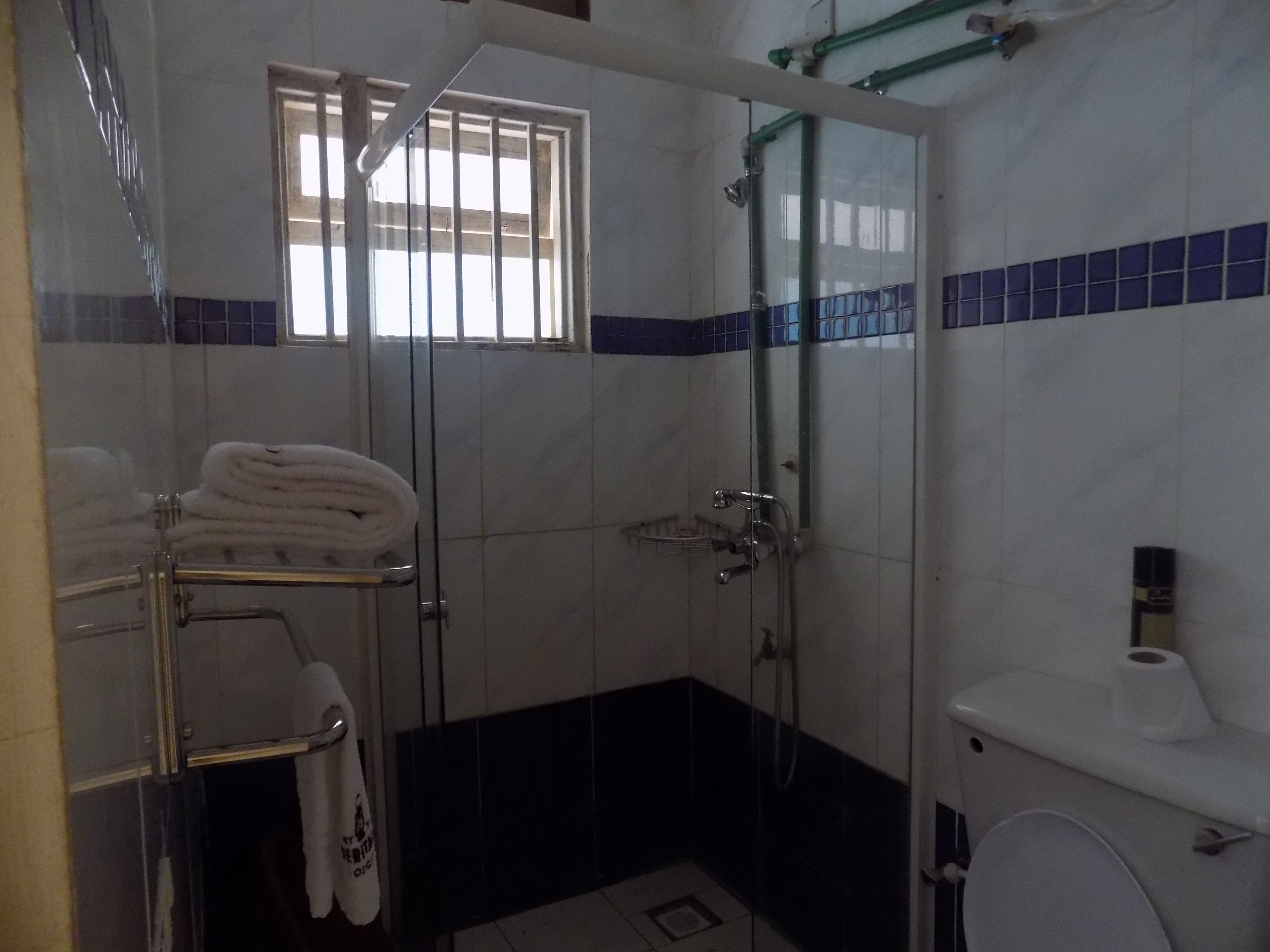 Shower, rainfall showerhead, towels, soap