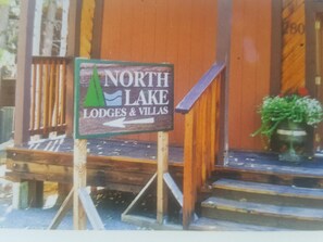 Welcome to North Lake Lodges & Villas, where a wooden sign directs you to the entrance.