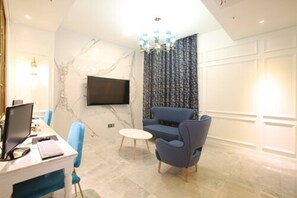 Royal Room (VIP) | Living area | 65-inch flat-screen TV with cable channels, TV