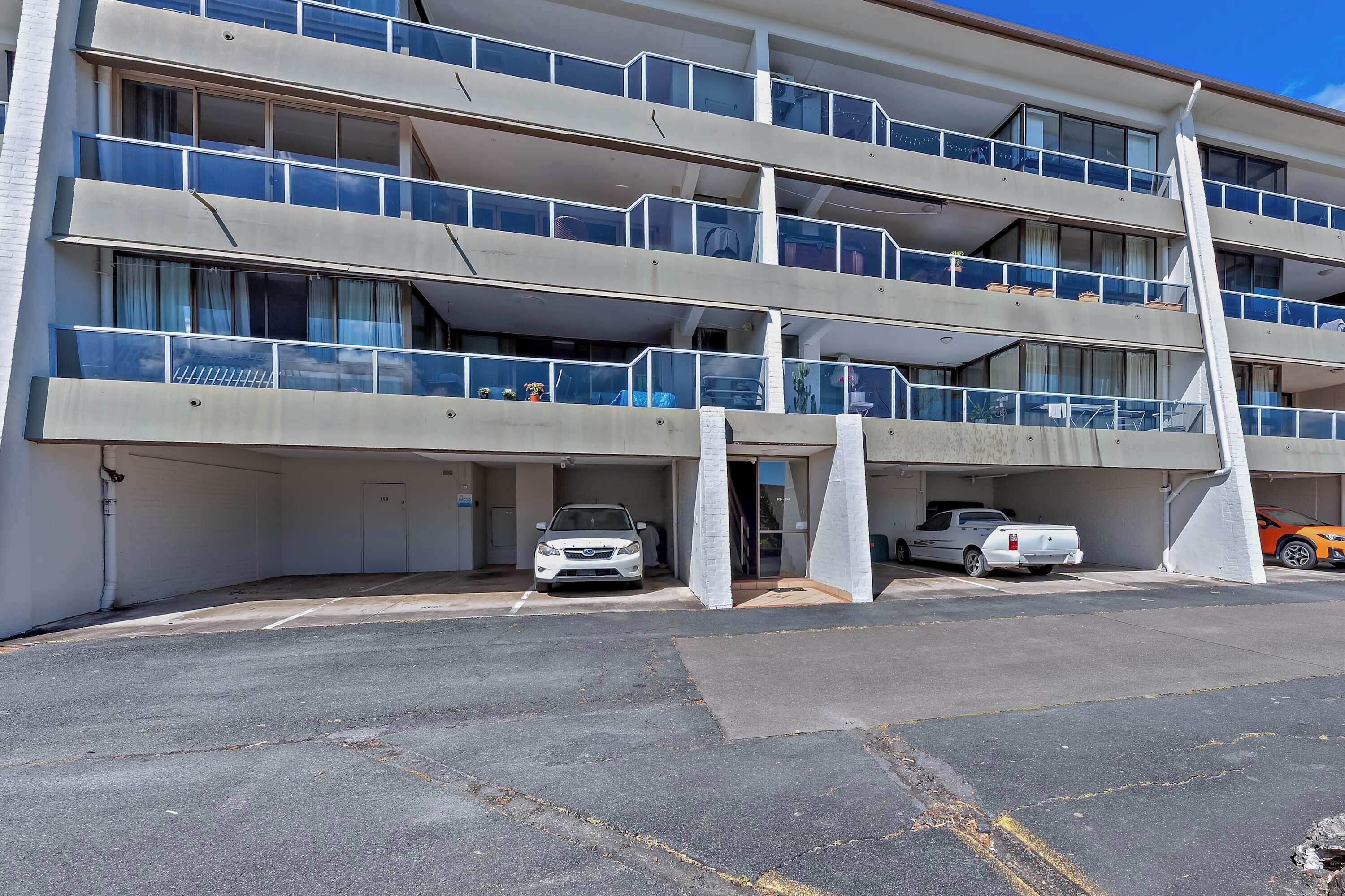 A multi-story parking garage with several cars parked.