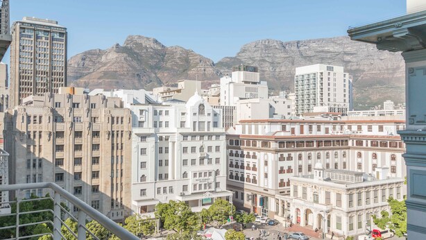A cityscape with historic buildings and a mountain backdrop. - Greenmarket 701 - Adults Only (Cape Town)