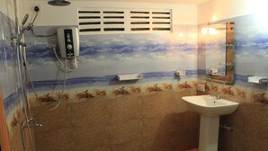 A bathroom with a shower, a sink, a mirror, and a wall with a beach mural.