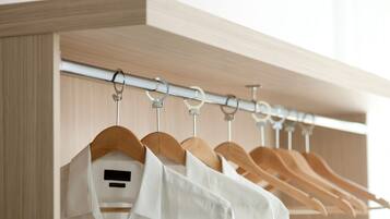 A closet with wooden hangers and a metal rod.