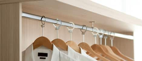 A closet with wooden hangers and a metal rod.