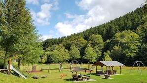 A park with picnic tables, a playground, and a gazebo. - Haus Onel 2 (Nordenau)