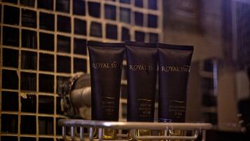 Three Royal Swedish brand toiletries on a metal shelf.