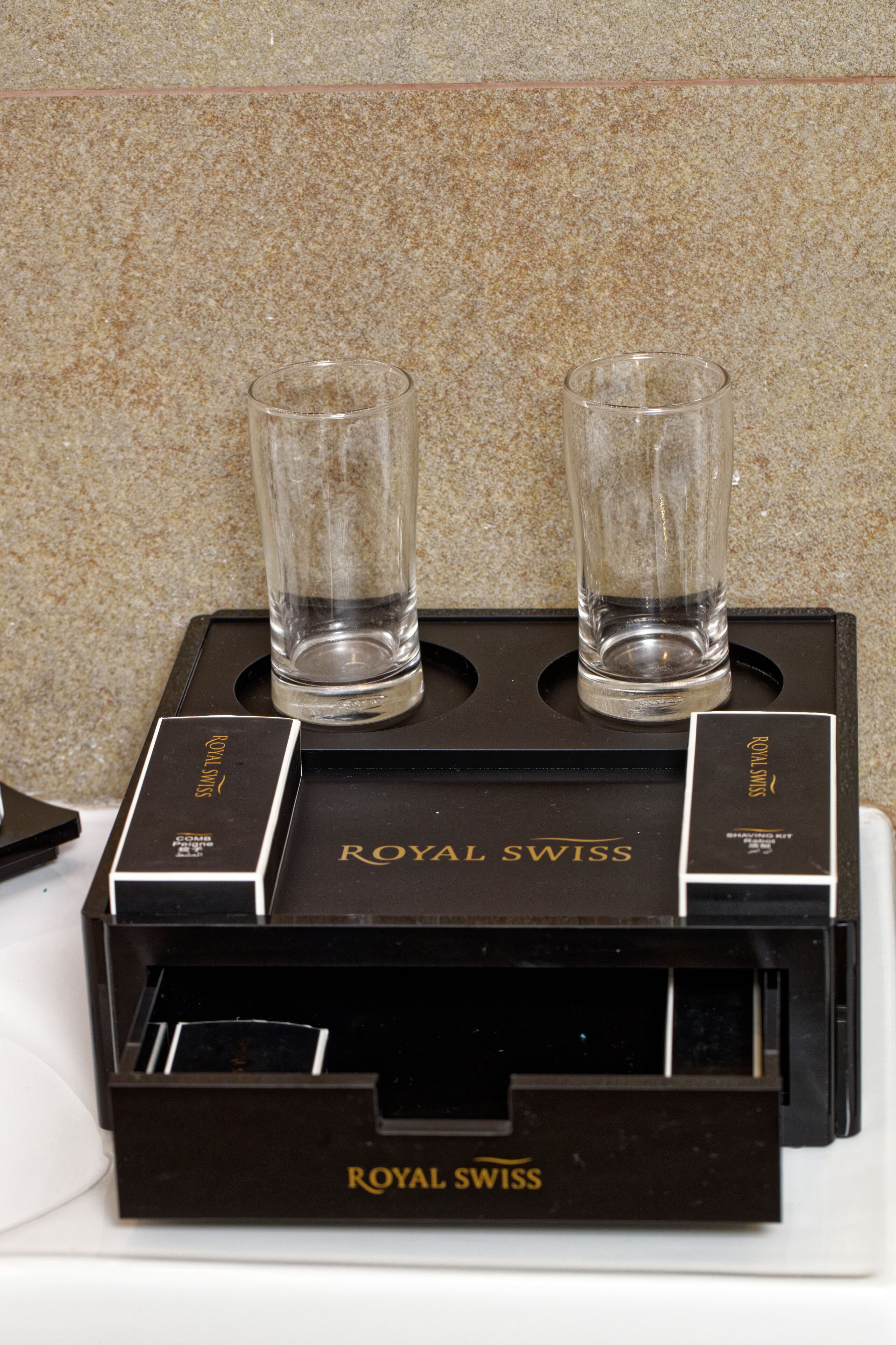 A black tray with two glasses and the text "ROYAL SWISS" on it.