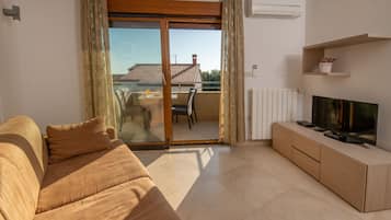 Superior Apartment, 1 Bedroom, Partial Sea View | Living area | Flat-screen TV
