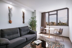 Apartamento superior, vista para a baía | Área de estar | Smart TV 40 polegadas com canais digitais