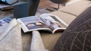 A modern living room with a sofa, a coffee table, a fireplace, and a bookshelf. - Lodges - Studio + Duplex (Annecy)