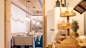 A restaurant interior with a rustic wooden ceiling, hanging pendant lights, and a stone wall backdrop. - Gästehaus Richter (Grainau)