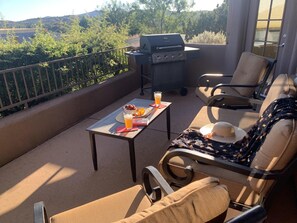 Enjoy al fresco dining with a barbecue grill and comfortable seating for two.