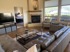 Relax in a stylish living room with a comfortable sofa, flat-screen TV, and fireplace.