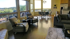 A spacious living area with a dining table and chairs, a sofa, and a view of the outdoors. - Popular West Sedona Home! 3BR 3BA, All Nearby! (Sedona)