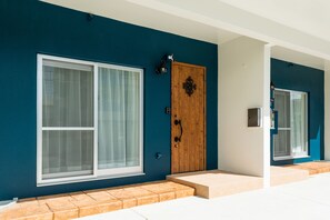 Stylish building with a clean, contemporary design, featuring a large window and a decorative door.