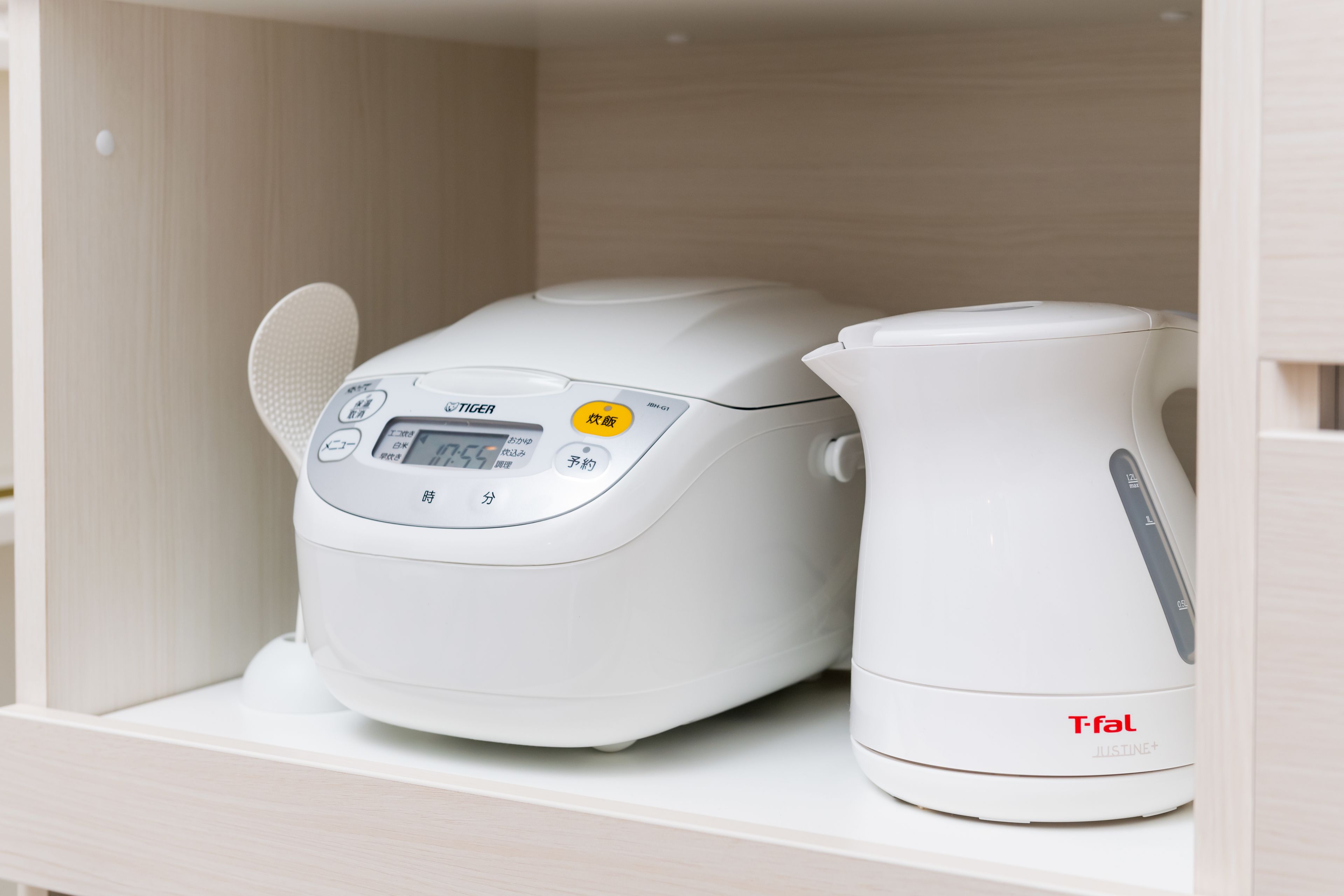 A white kitchen appliance with a digital display and a kettle.