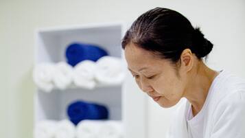 Experience a soothing massage therapy session in a serene, clinical setting.