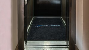 An elevator with a metallic interior, a control panel, and a floor indicator. - Apart-Hostel ZERO (Bratislava)