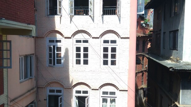 A multi-story building with arched windows and balconies. - Big Bell Guest House (Bhaktapur)