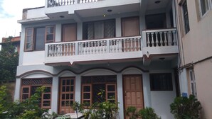 A multi-story building with balconies, large windows, and a traditional architectural style. - Big Bell Guest House (Bhaktapur)