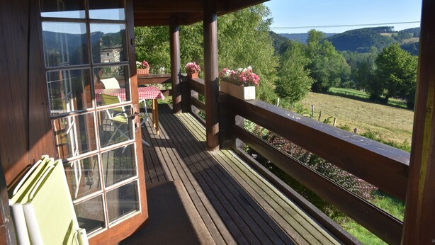 A wooden deck with a view of a green landscape. - Scandinavian chalet, warm atmosphere, for those who love nature (Lierneux)