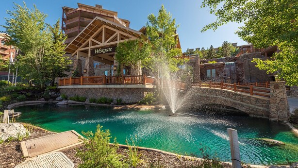 A Westgate hotel with a stone bridge over a turquoise pool, surrounded by lush greenery and a waterfall feature. - Coming soon! Coming soon! Coming soon! Coming soon! Coming soon! (Park City)
