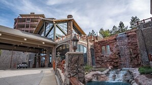 A modern building with a large glass facade, a stone exterior, and a waterfall feature. - Coming soon! Coming soon! Coming soon! Coming soon! Coming soon! (Park City)