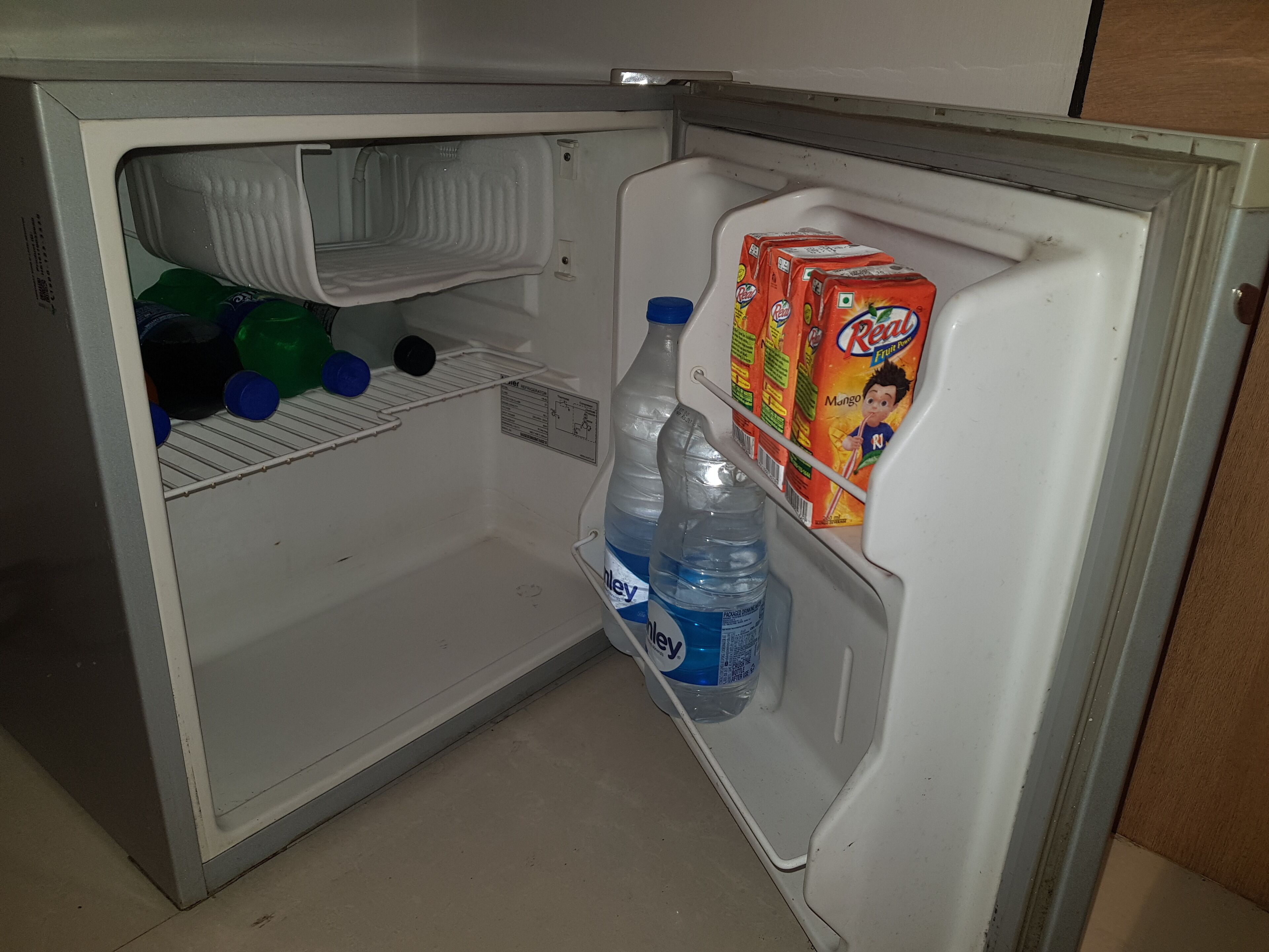 An open refrigerator with shelves and a door shelf.