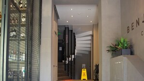 A hotel entrance with a staircase leading to a reception area. - The Hera Suit Hotels (Istanbul)