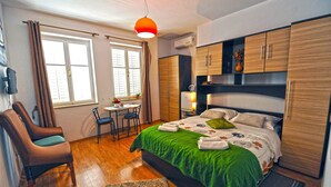 A bedroom with a bed, a desk, a chair, and a wardrobe. - Villa Katarina - Double Room with Sea View (First Floor) (Dubrovnik)