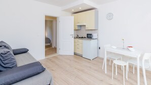 A compact living space with a kitchenette, a dining area, and a sofa. - Color Apartments - Comfort One Bedroom Apartment with Terrace and Partial Sea View (Mlini)
