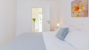 A bedroom with a bed, a nightstand, a lamp, and a painting on the wall. - Color Apartments - Comfort One Bedroom Apartment with Terrace and Partial Sea View (Mlini)