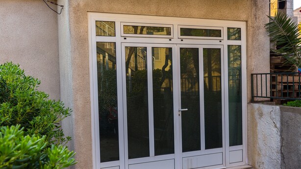A white sliding glass door with a black doormat at the base. - Apartment Basic - One Bedroom Apartment (Dubrovnik)